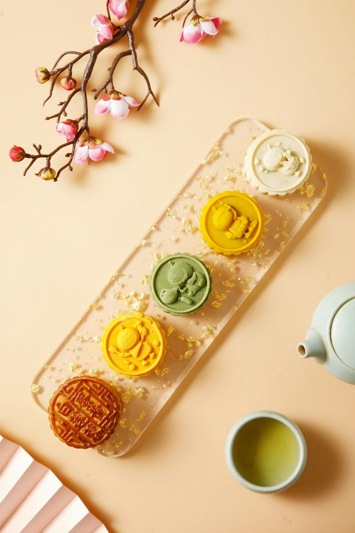 A colorful display of various oriental pastries including baklava and kunefe